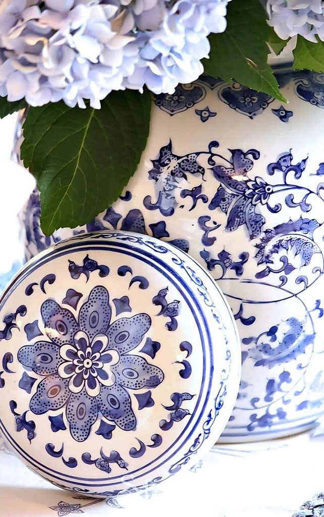 blue and white urn with blue hydrangeas in it