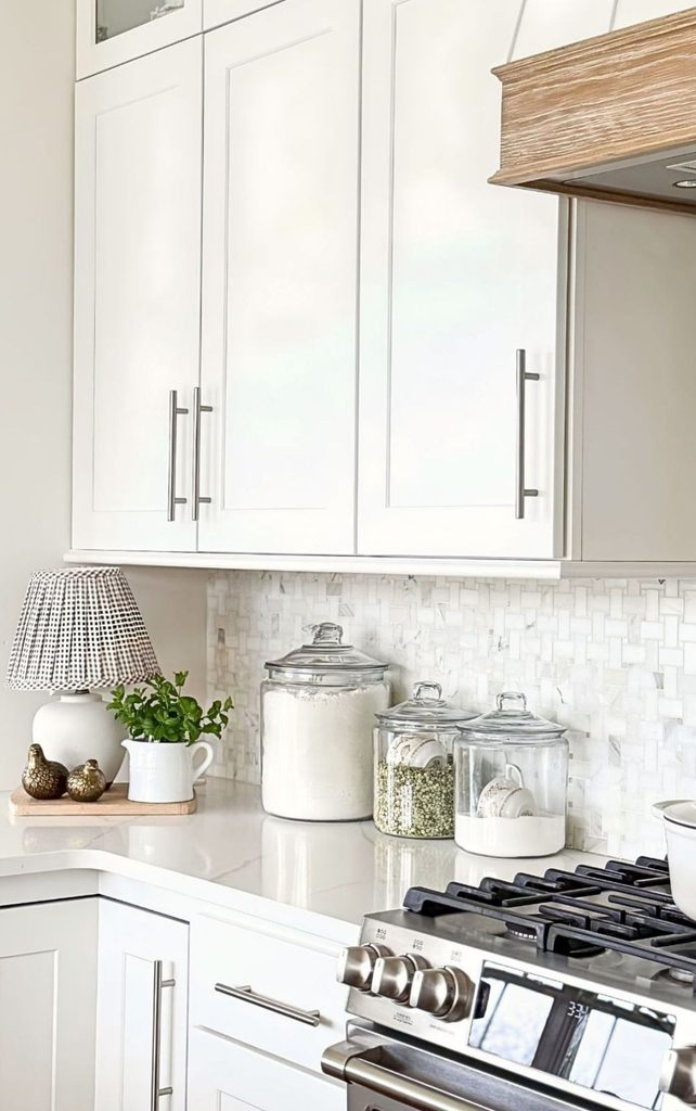 kitchen countertops with glss canisters and a lamp